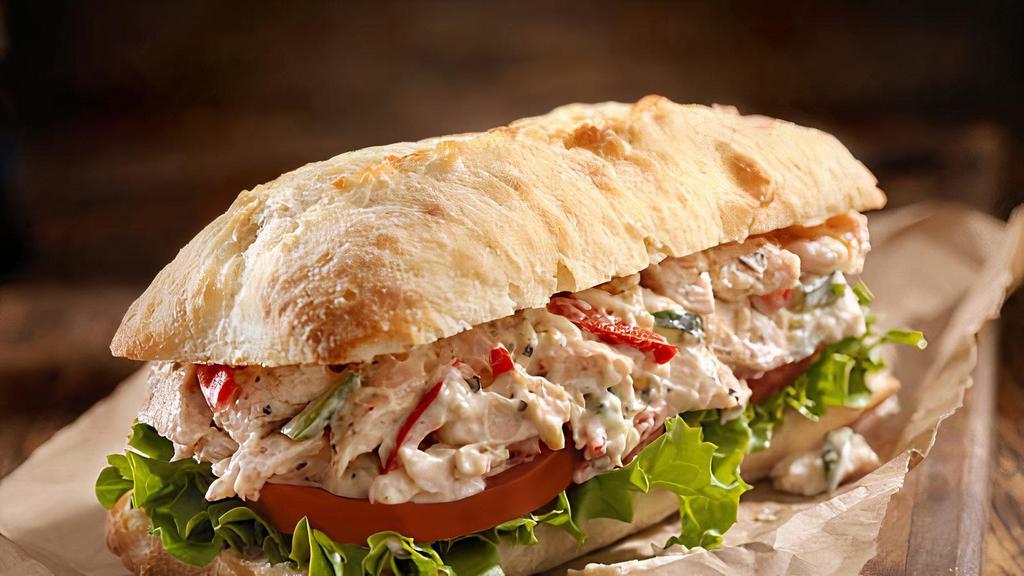 Chicken Moo & Nellie · Sautéed onions and garlic, baby bell peppers (none of those green), roasted and sliced chicken, Moo & Nellie sauce, Muenster, romaine, and tomato served on cellone's hoagie bun with a side of Italian aioli and a small fry.