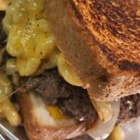 Dope Burger · A burger patty topped with grilled onions, and mac & cheese. Served on a Texas toast bread.