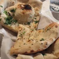 Garlic Naan · Vegetarian. Bread baked in a clay oven and seasoned with garlic.