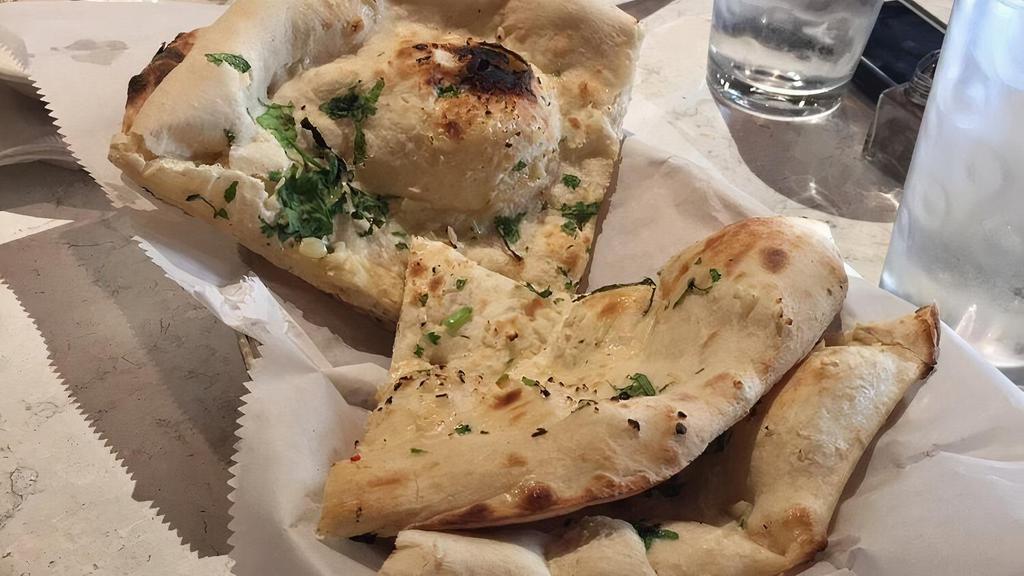 Garlic Naan · Vegetarian. Bread baked in a clay oven and seasoned with garlic.