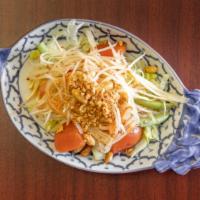 Papaya Salad · Authentic Thai cuisine: salad with a mixture of green papaya, peanut, lime juice, and tomato.