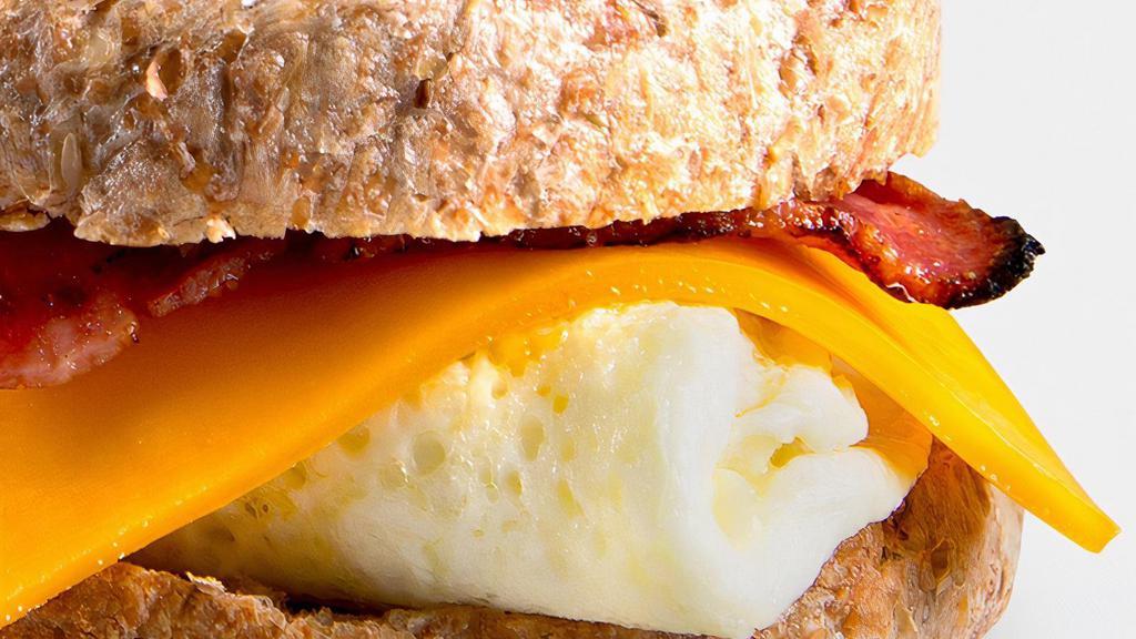 Breakfast Sandwich · 4 egg whites, turkey bacon, low-fat cheddar. Served on Ezekiel English muffin and side of fruit.