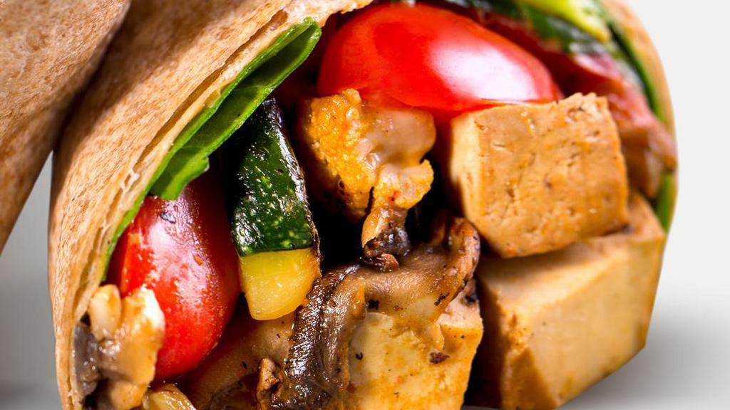 Power Wrap · Organic non-GMO tofu, sauteed squash, spinach, hummus, chopped garlic, red peppers, cherry tomatoes, mushrooms and PH spicy peanut sauce served on whole wheat tortilla and side of fruit. Vegan.