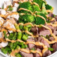 Thai Monster Bowl · All-natural chicken, certified Angus beef steak, broccoli, asparagus, green onions, and hous...