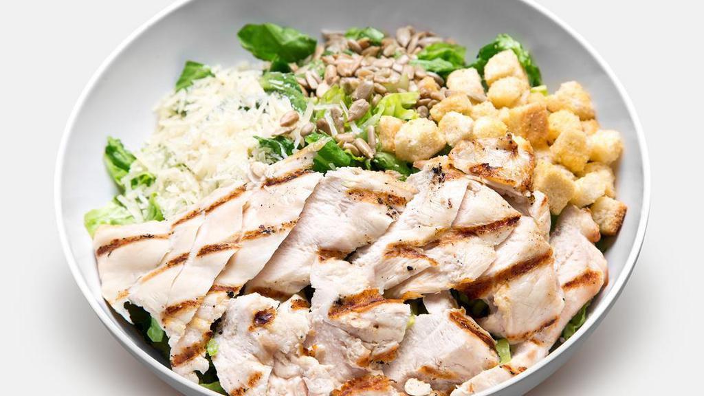 Chicken Caesar Salad · Grilled all-natural chicken, romaine lettuce, Parmesan cheese, sunflower seeds, croutons, and light Caesar dressing.
