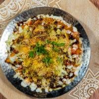 Samosa Chaat · Two chopped samosas smothered with chick peas and topped with mint, tamarind chutney, yogurt...
