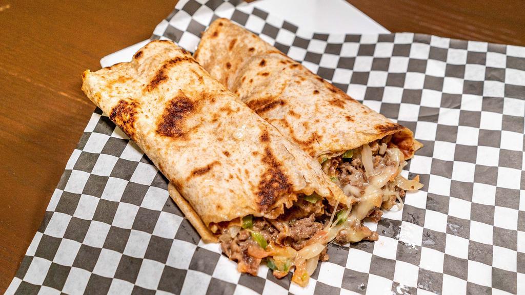 The Philly Wrap · Seasoned Philly beef, onions, green poppers, mushrooms, Swiss cheese, fusion sauce on toasted chapati.