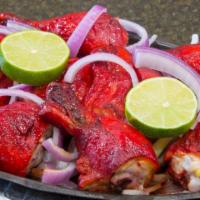 Tandoori Chicken · Spring Chicken marinated in yogurt with fresh spices and lemon then barbecued in the tandoor.