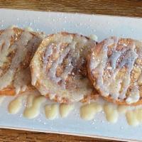 *Cinnamon Roll French Toast · A cinnamon roll sliced and grilled in our signature french toast batter topped with powdered...
