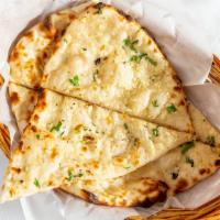 Garlic Naan · Traditional indian bread baked in clay oven and garnished with garlic and herbs.