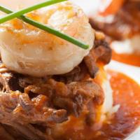 Short Ribs + Shrimp · Pulled beef short ribs, three sautéed shrimp, white cheddar grits, and tomato jus on the sid...