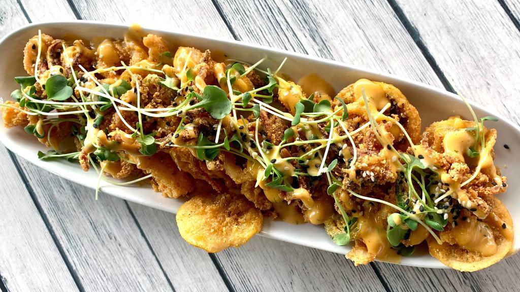 Sweet + Spicy Calamari · Fried calamari, jalapenos, lemon wheels, daikon sprouts, and sesame seeds; served with sweet & sour aioli on the side