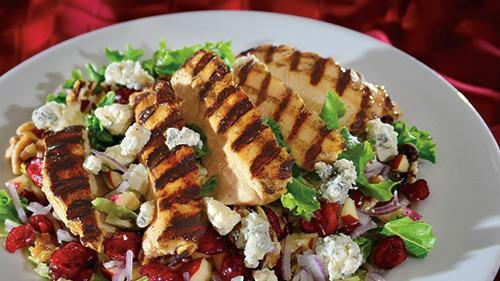 Chopped Wisconsin Harvest · We toss fresh greens, apples, dried cranberries, and red onions topped off with toasted walnuts and bleu cheese. Served with fat-free raspberry vinaigrette dressing.