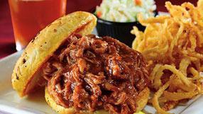 Pulled Pork Sandwich · Shredded slow roasted pork blended with BBQ sauce on an onion bun. Served with cole slaw.