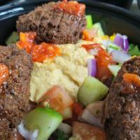 Mediterranean Falafel Bowl · Starting with a bed of romaine lettuce, saffron basmati rice, house made hummus, Jerusalem s...