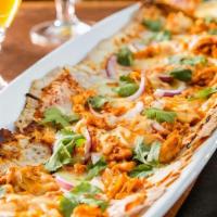 Bbq Chicken Flatbread · House smoked BBQ chicken, mozzarella, gouda, red onion, housemade BBQ sauce.