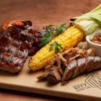 Smoked Bbq Platter · Baby back ribs, grilled chili-rubbed wings, pulled pork, Louisiana hot link, butter grilled ...
