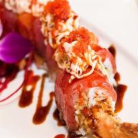 #74. Dream Roll · Tuna, salmon, spicy crab meat, tobiko and spicy sauce over shrimp tempura.