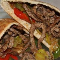 Shawarma (Gyro) (Lamb & Beef) · Home style sliced roasted lamb and beef, with tomatoes, cucumber, pickled and topped with ta...