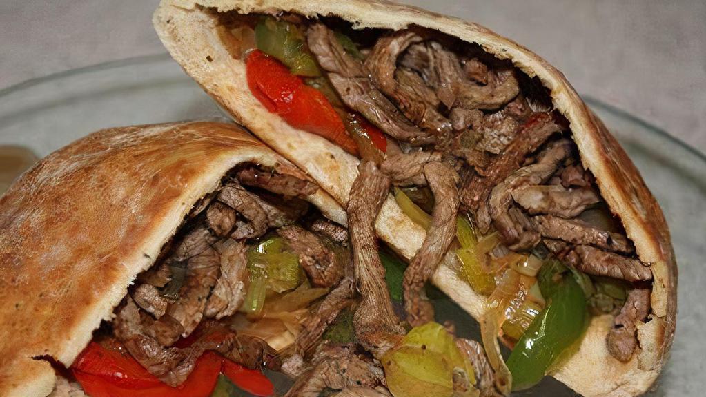 Shawarma (Gyro) (Lamb & Beef) · Home style sliced roasted lamb and beef, with tomatoes, cucumber, pickled and topped with tahini sauce. Made with our fresh baked bread.
