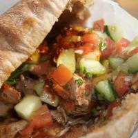 Shawarma (Gyro) (Chicken) · Home style sliced chicken with tomatoes, cucumber, pickled, topped with garlic sauce. Made w...