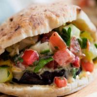 Iraqi Kabab Sandwich · Charcoal roasted lamb or beef, tomatoes, and dressed with tahini sauce.