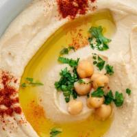 Hummus · A blend of ground chickpeas, tahini sauce, topped with extra virgin olive oil.