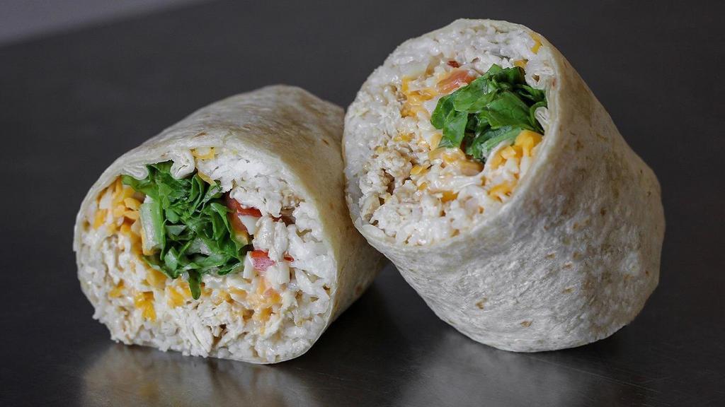 Chipotle Ranch Burrito · Chicken, chipotle ranch, cheddar cheese, rice, romaine lettuce, tomatoes, and onions.