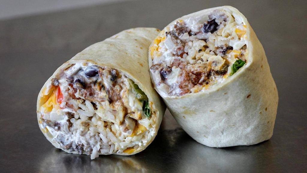 Mamma Grande · Regular size burritos only!! 

A traditional burrito with choice of protein, choice of salsa, choice of beans, romaine lettuce, sour cream, lime juice, red peppers, fresh cilantro, rice, cheddar cheese, and onions.