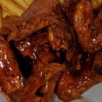 Chicken Wings · Whole wings.

Choose one sauce: Buffalo, Honey BBQ, Sweet Chili, Garlic Parmesan, Spicy Bour...
