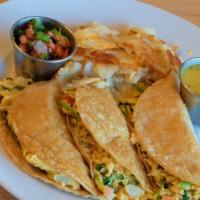Breakfast Tacos · Three fresh corn or flour tortillas topped with scrambled eggs, choice of potatoes, Chihuahu...