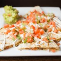 Quesadillas · Grilled flour tortilla stuffed with melted Chihuahua cheese and topped with guacamole, sour ...