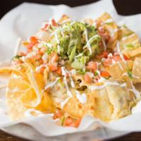 Nachos · Fresh tortilla chips, refried beans, melted chihuahua topped with guacamole, jalapenos, pico...