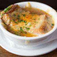 French Onion Soup · Caramelized onions in a beef broth with garlic croutons and melted Swiss cheese.