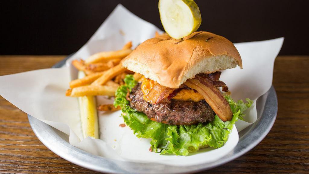 Merkt'S Cheddar Burger · 8 oz. burger topped with Merkt's cheddar cheese spread, balsamic charred red onions, Applewood smoked bacon, lettuce and tomato on a toasted old-fashioned bun. Served with choice of side and a kosher dill pickle.
