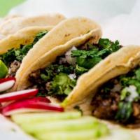 Tacos · Authentic Mexican tacos served with onions, cilantro, and salsa