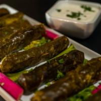 Meat Grape Leaves · Grape leaves stuffed with rice, meat and spices. Served with yogurt.