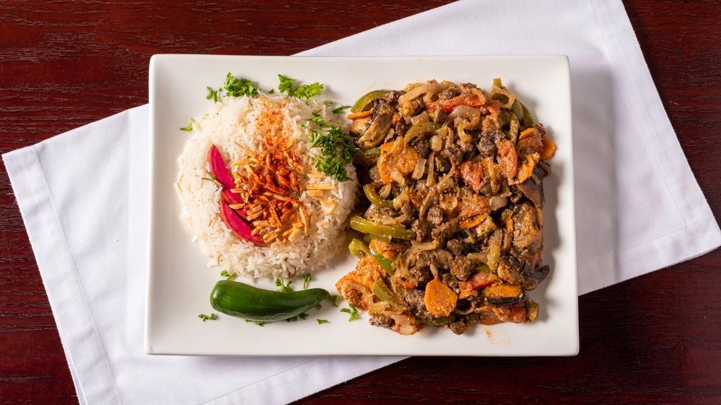 Ghallaba · Chicken, lamb sauteed with vegetables, herbs, and our house spices. Served with rice or fries and your choice soup or salad.