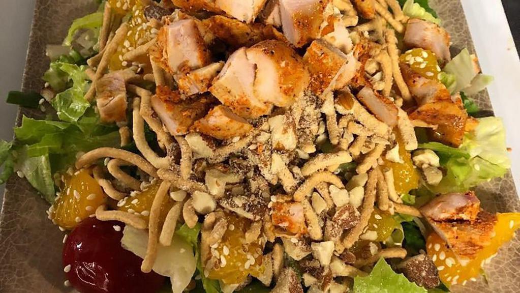 Asian Salad · Romaine, grilled chicken breast, peppadew peppers, sliced almonds, sesame seeds, chow mein noodles, mandarin oranges, and Asian dressing.