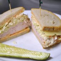 6 1/2. Big Mouth Turkey · Oven-roasted turkey, Swiss cheese, coleslaw, and Russian dressing on double-baked rye.
