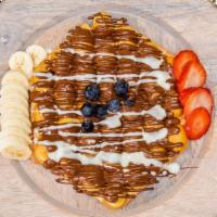 Fruity Waffle · Crispy waffle topped with strawberry and banana drizzled with three kinds of Belgian chocola...