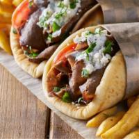 Chicken Gyro Combo · Delicious gyro made with chicken gyro, garlic spread, shredded lettuce, and pickled turnips....