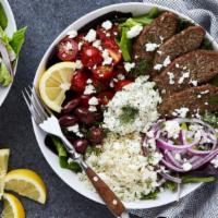 Lamb Gyro Hummus Bowl Combo · Hummus bowl with strips of lamb gyro, farmers salad and a pita bread. Served with a side of ...