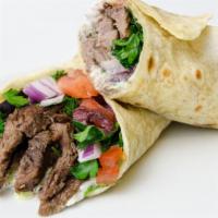 Beef Shawarma Wrap · A flour tortilla with skirt beef steak, red onions, parsley, sumac mix, diced tomatoes, pick...