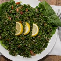 Tabbouleh (Small) · Diced parsley, red onions, tomatoes, cracked wheat, tossed with lemon and olive oil.