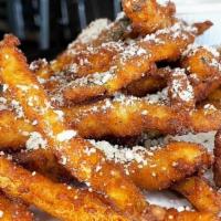 Zucchini Fries · Fresh cut, breaded, and then fried topped with parmesan and served with garlic aioli.