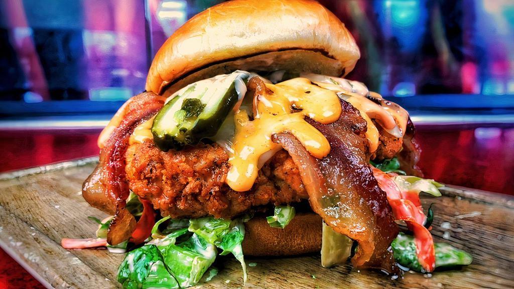 Flamme Fried Chicken · Buttermilk Breaded Fried Chicken Breast, Applewood Smoked Bacon, Jalapeno Jack Cheese, Pickle, Sriracha Aioli Slaw, and Sriracha Aioli Drizzle.