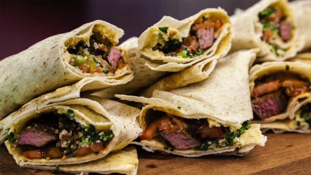 Lamb Kati Roll · Indian street food version of the burrito. Lamb Tikka cubes rolled in flat-bread with fresh veggies with a perfect medley of fresh, tangy, and sweet and spicy chutneys (sauces).