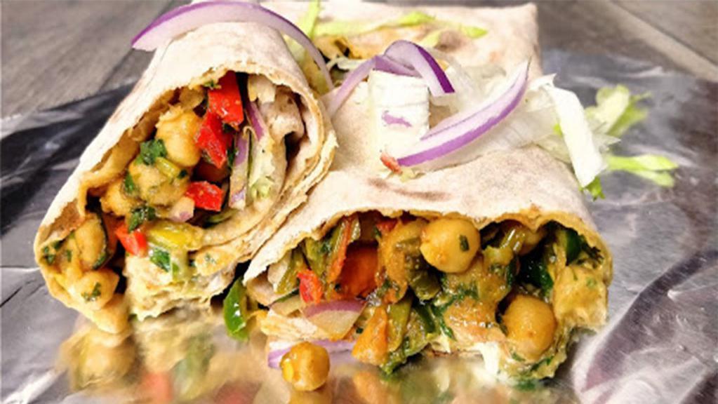 Chickpea Kati Roll · Indian street food version of the burrito. Chickpeas rolled in flat-bread and fresh veggies with a perfect medley of fresh, tangy, and sweet and spicy chutneys (sauces).