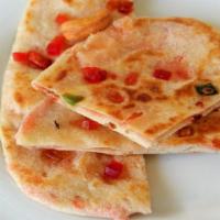 Kashmiri Naan · Flatbread Filled with minced verify or dry nuts and raisins.